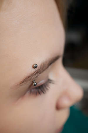 smile or frenulum piercing under the upper lip.の写真素材
