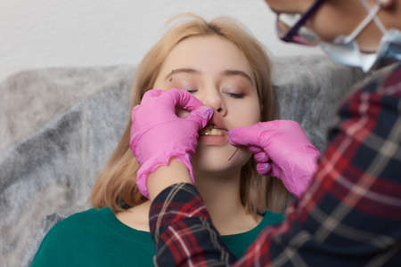 smile or frenulum piercing under the upper lip.の写真素材