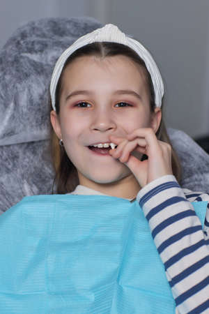 girl portrait with a lost tooth Teenager child with a tooth dropped out.