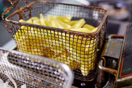 Dirty cooking area with french fries deep fryer.の写真素材