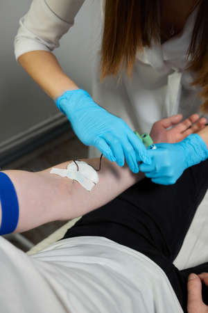 Beautician doctors hands put test tube with blood in centrifuge container. Rejuvenation...