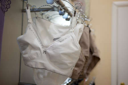 Vareity of bra hanging on a hanger. Textile, Underwear. Female bra in lingerie underwear store. Advertise, sale, fashion concept.の写真素材