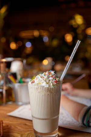 Chocolate indulgent frosting exreme milkshake with donut and sweets. Crazy freakshake food trend. Copy space.の写真素材