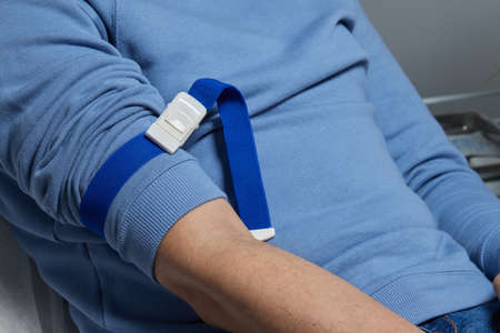 the doctor collects blood in a syringe, Nurse takes blood from the veins on the arm.