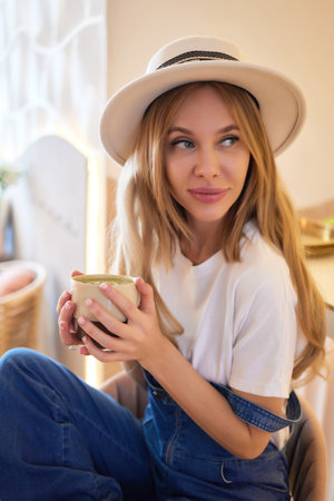 Cheerful woman drinking coffee communication morning rest.の写真素材