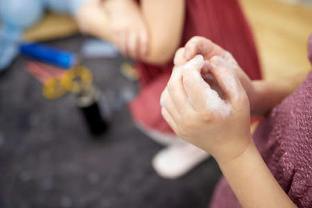 Childrens hands in soapy foam.Clean hands concept. Hygiene and health.の写真素材