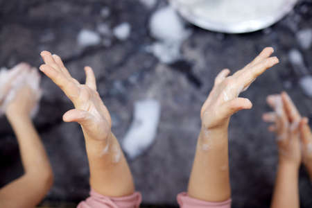 Childrens hands in soapy foam.Clean hands concept. Hygiene and health.の写真素材