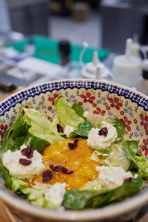 flat lay of plate with apricot, arugula and feta cheese salad on wooden table.の写真素材