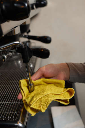 A perfectly lit cleaning cloth sat upon an espresso machine.の写真素材