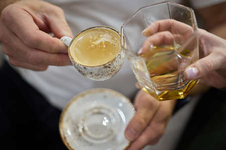 ceramic cup of coffee, glass of cognac.
