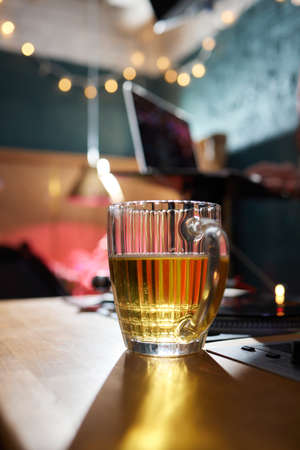 Half a mug of fresh beer with foam.の写真素材