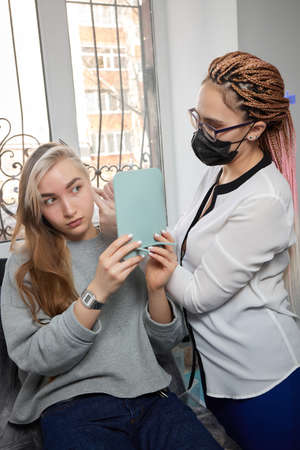 Professional holding the jewel of piercing day just before screw the ball. Tragus type.