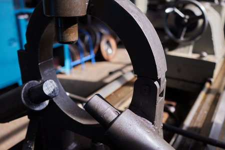 Close up of the CNC lathe jaw clamping raw material steel rod .Steel Cylinder part after turning process. Hi-precision CNC machining concept.Raw material steel rod for CNC lathe precess.の写真素材