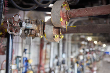 Close-up at pipeline valve which is using to control production process in the oil refinery plant....