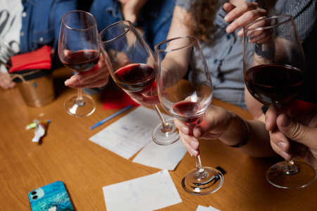 Celebrating with glasses of alcohol in hands. Happy female friends having good time.の写真素材