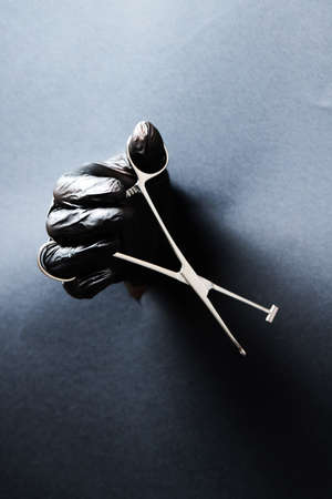 hand-held stainless steel surgical scissors with gloves.の写真素材