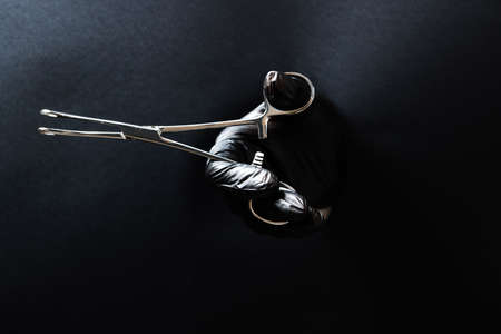 hand-held stainless steel surgical scissors with gloves.の写真素材