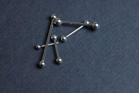 Piercing earrings close-up. On a black background.