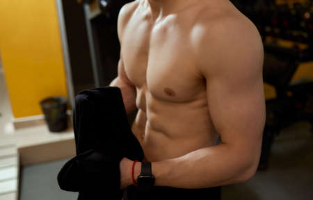The young man took off his shirt and stretched his body, making his body sweat rise up over his...