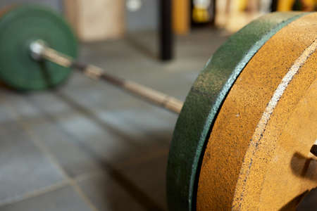 Barbell bar and barbell plate on background.の写真素材