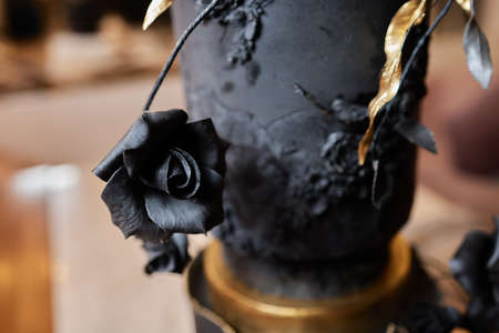 Black bunk cake on the dark black background with golden stars and spheres decoration on top. luxurious birthday cake.の写真素材