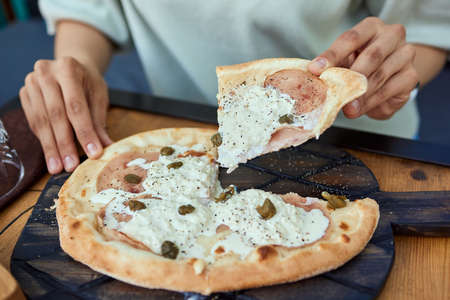 Very cheesy pizza of six kinds of cheese and pistachios. Italian food concept. Top view.の写真素材