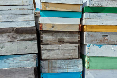 Beekeeper beekeeping background wallpaper - Wall texture made of many old rustic wooden beehives stacked on top of each other.の写真素材