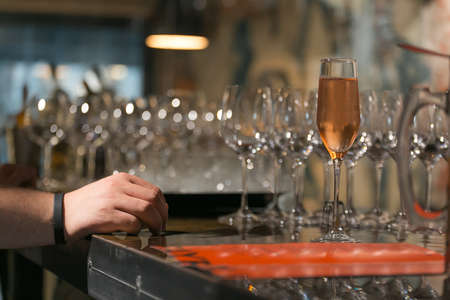 Wine glasses in warm light loft restaurant.