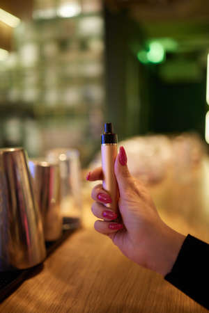 middle aged woman is exhaling vape smoke.の写真素材