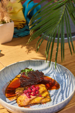 Beef cheek steak, caramelized in wine sauce with chanterelles in a plate.