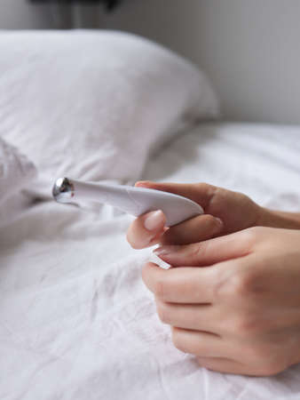 beautiful girl in sexy clothes holding in her hands a sex toy for adults.の写真素材