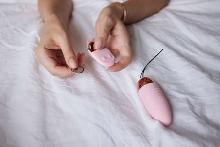 beautiful girl in sexy clothes holding in her hands a sex toy for adults.の写真素材