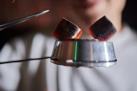 Burning red coals for hookah during preparation.