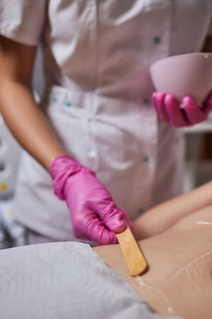 Rf skin tightening, belly. Hand of cosmetician, female body. Non surgical body sculpting.