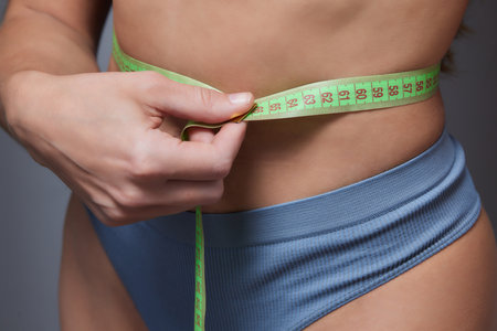 Diet, Sporty Woman Showing How Much Weight She Lost.の写真素材