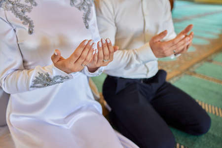 Bride and groom Asian Muslims marry in a beautiful red love theme. celebration nikah day.の写真素材