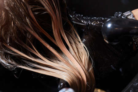 Airtouch Hair stylist makes bouffant using comb on thin strands. Shatush technique for hair...