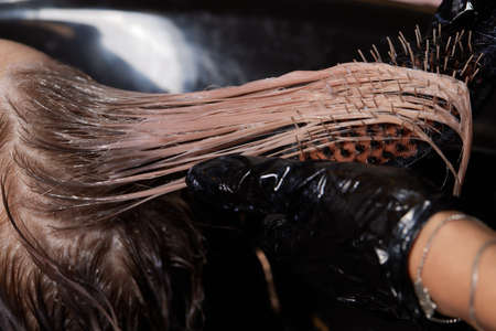 Airtouch Hair stylist makes bouffant using comb on thin strands. Shatush technique for hair lightening.の写真素材