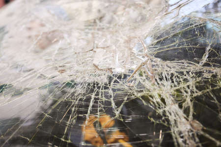 Broken glass in car. Close-Up Of Shattered Windshield.の写真素材