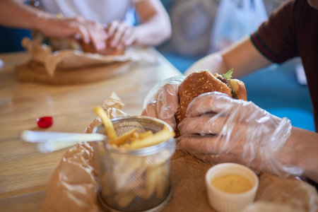 Burger with mushrooms, meatballs, tomato and lettuce on wooden background. Close up.の写真素材