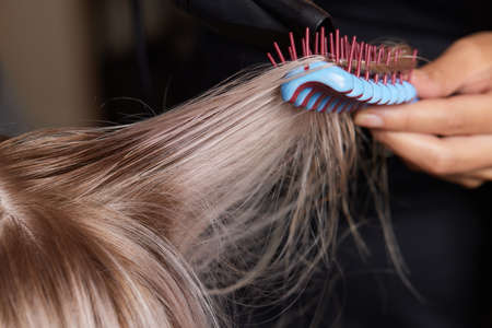 Airtouch Hair stylist makes bouffant using comb on thin strands. Shatush technique for hair lightening.の写真素材