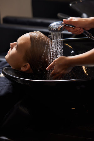 Hairstylist Hairdresser Washing Customer Hair - Young Man Relaxing In Hairdressing Beauty Salon.の写真素材
