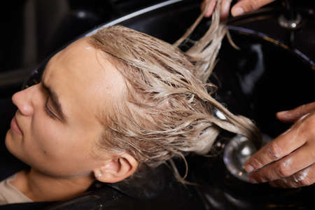 Hairstylist Hairdresser Washing Customer Hair - Young Man Relaxing In Hairdressing Beauty Salon.