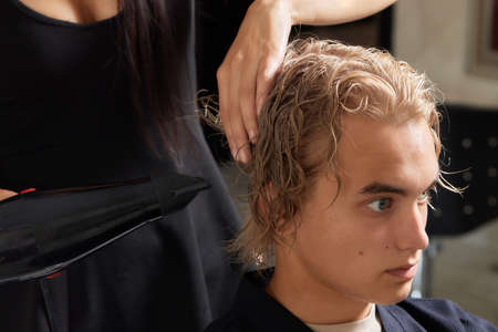 Airtouch Hair stylist makes bouffant using comb on thin strands. Shatush technique for hair lightening.の写真素材