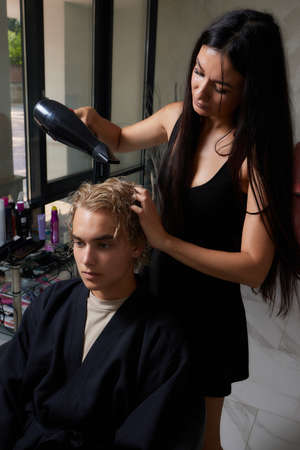 Airtouch Hair stylist makes bouffant using comb on thin strands. Shatush technique for hair lightening.の写真素材