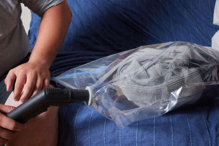 Space saver saving seal bag sucking air vacuum clothing storage compressed package.