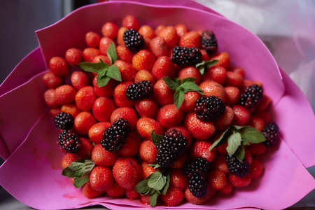 Delicious bouquet of strawberries and roses. Close up.の写真素材