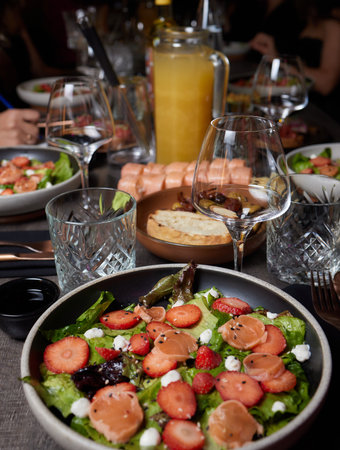 Salmon Salad with spinach, cherry tomatoes, corn salad, baby spinach, fresh mint and basil. Home made food. Concept for a tasty and healthy meal. Dark stone background. Top view. Close up.の写真素材