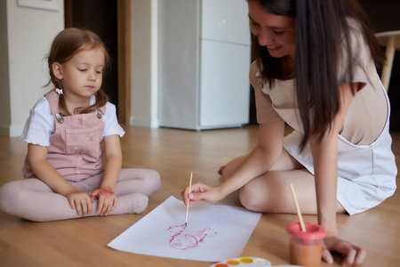 Little girl and their mother playing on warm floor with underfloor heating in living room. watercolor painting.の写真素材