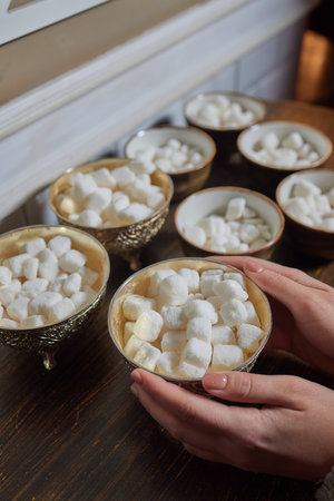 Sugar Bowl with cubes of white cane sugar, sugar-tongs and napkins. Atmosphere and table appointments in the city cafe.の写真素材